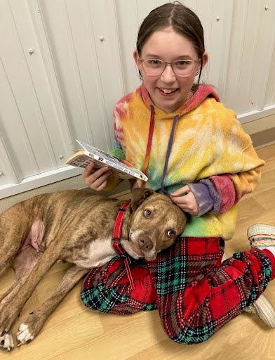 Girl with book and dog